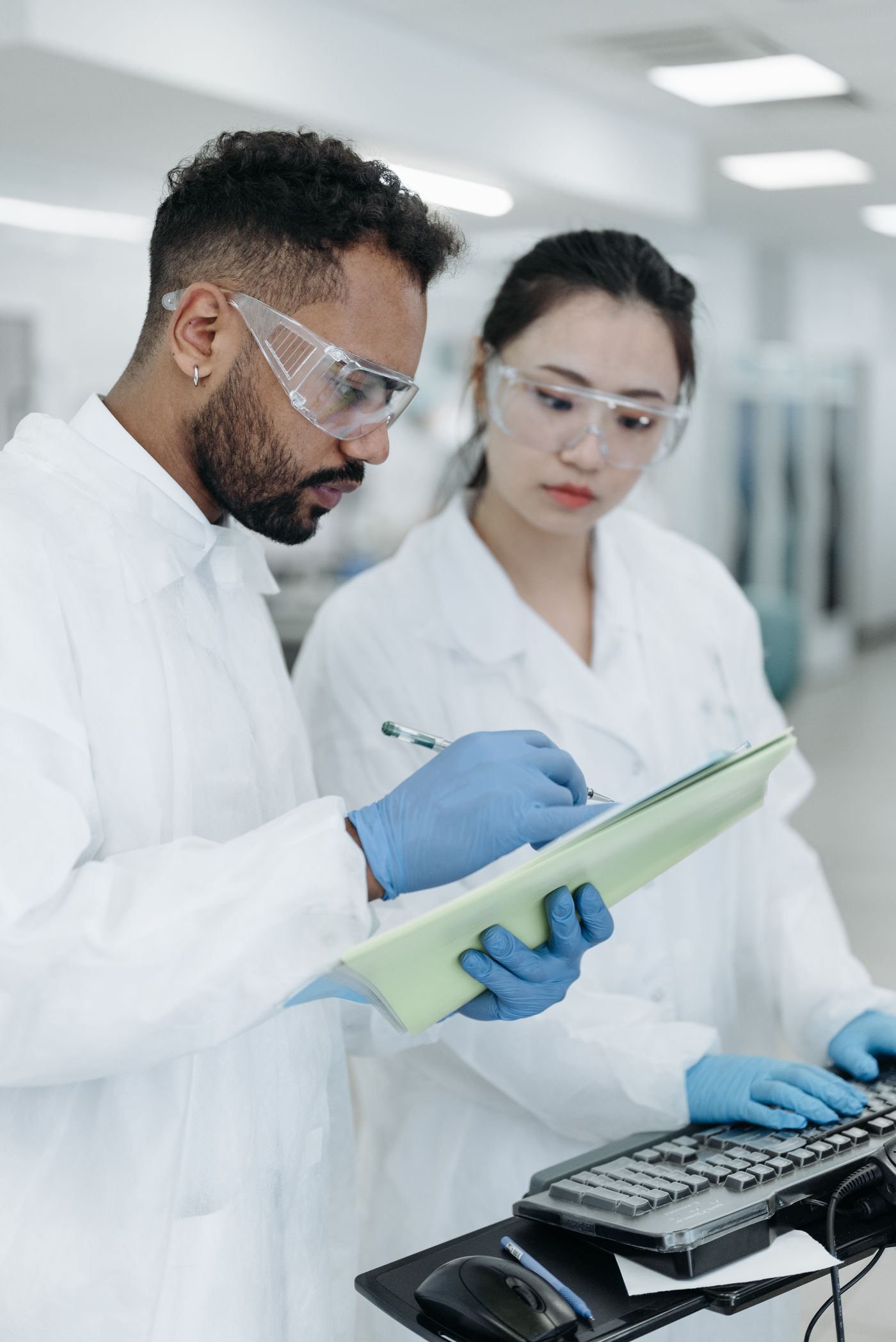 Scientists reviewing research notes together at a laboratory computer